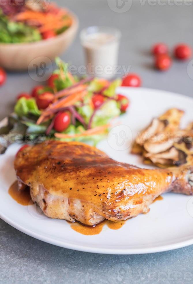 Grilled chicken steak with teriyaki sauce on dining table photo