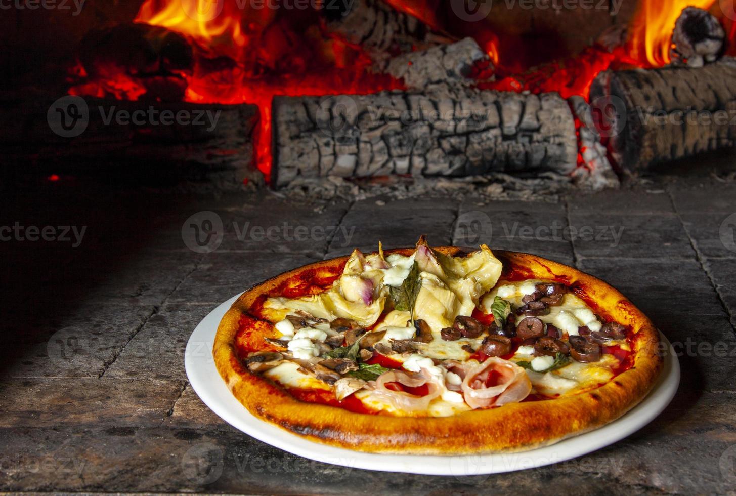 Baked pizza in the wood oven photo