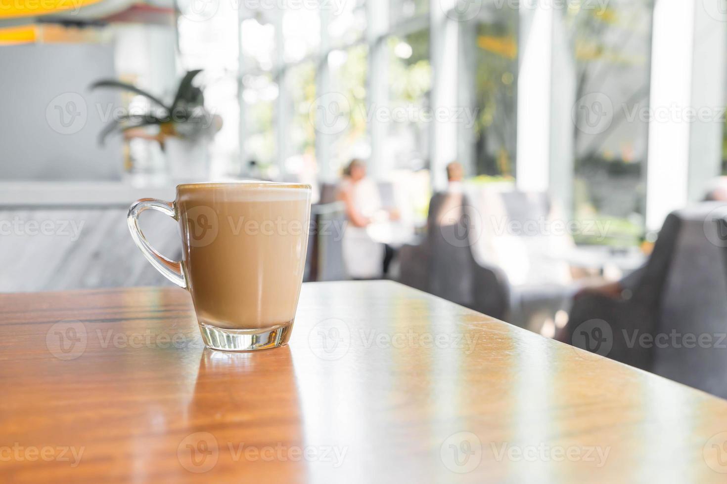 Hot latte coffee cup in coffee shop photo