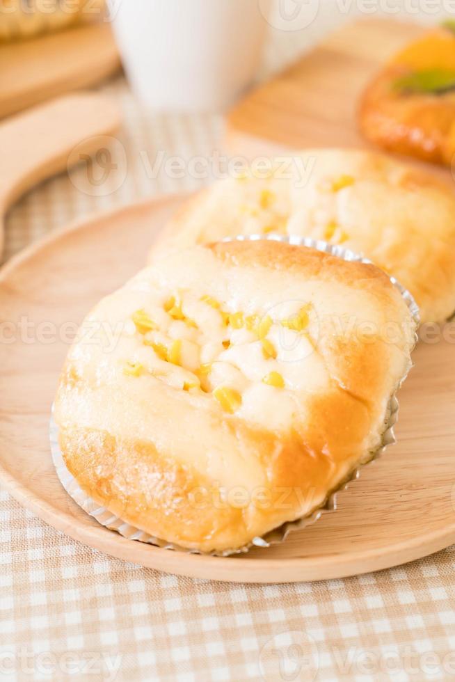 Bread with corn and mayonnaise on the table photo