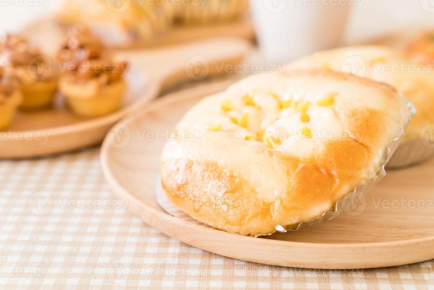 Bread with corn and mayonnaise on the table photo