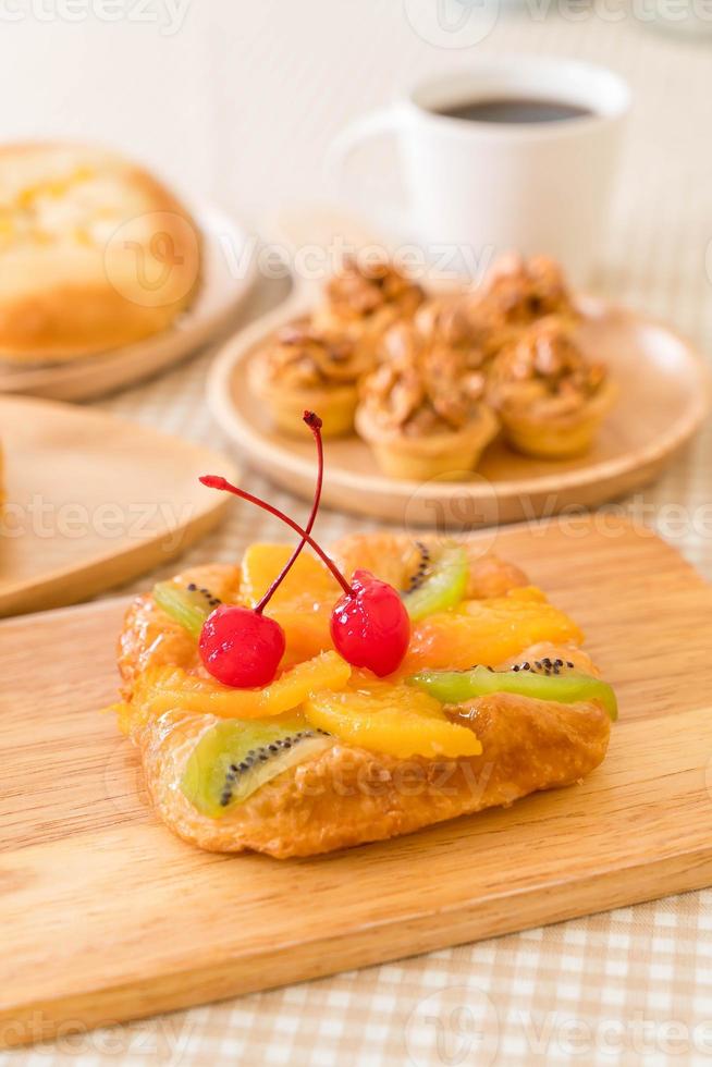 Mezcla de frutas danesas con mermelada en la mesa foto