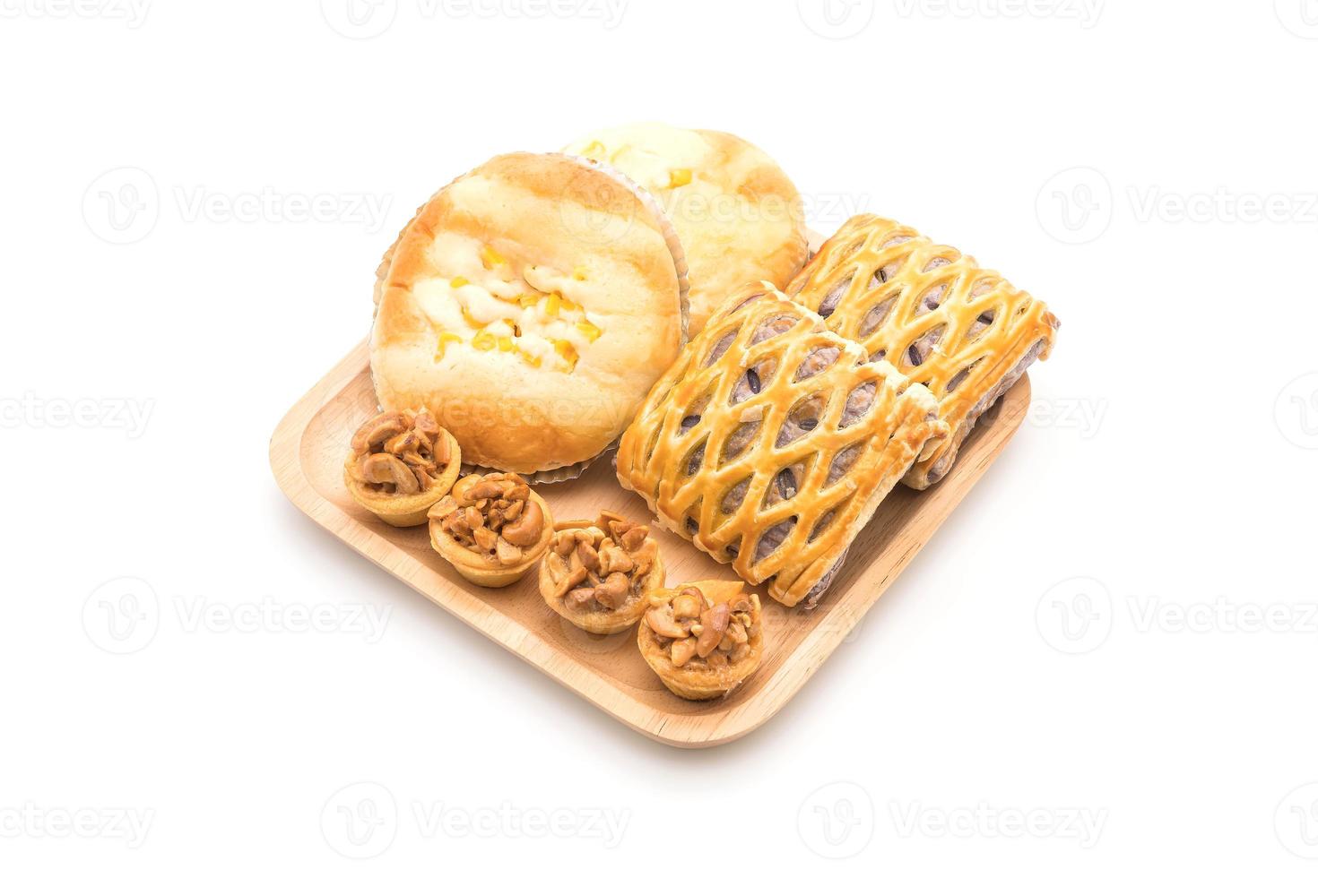 Toffee cake, bread with corn mayonnaise, and taro pies on white background photo