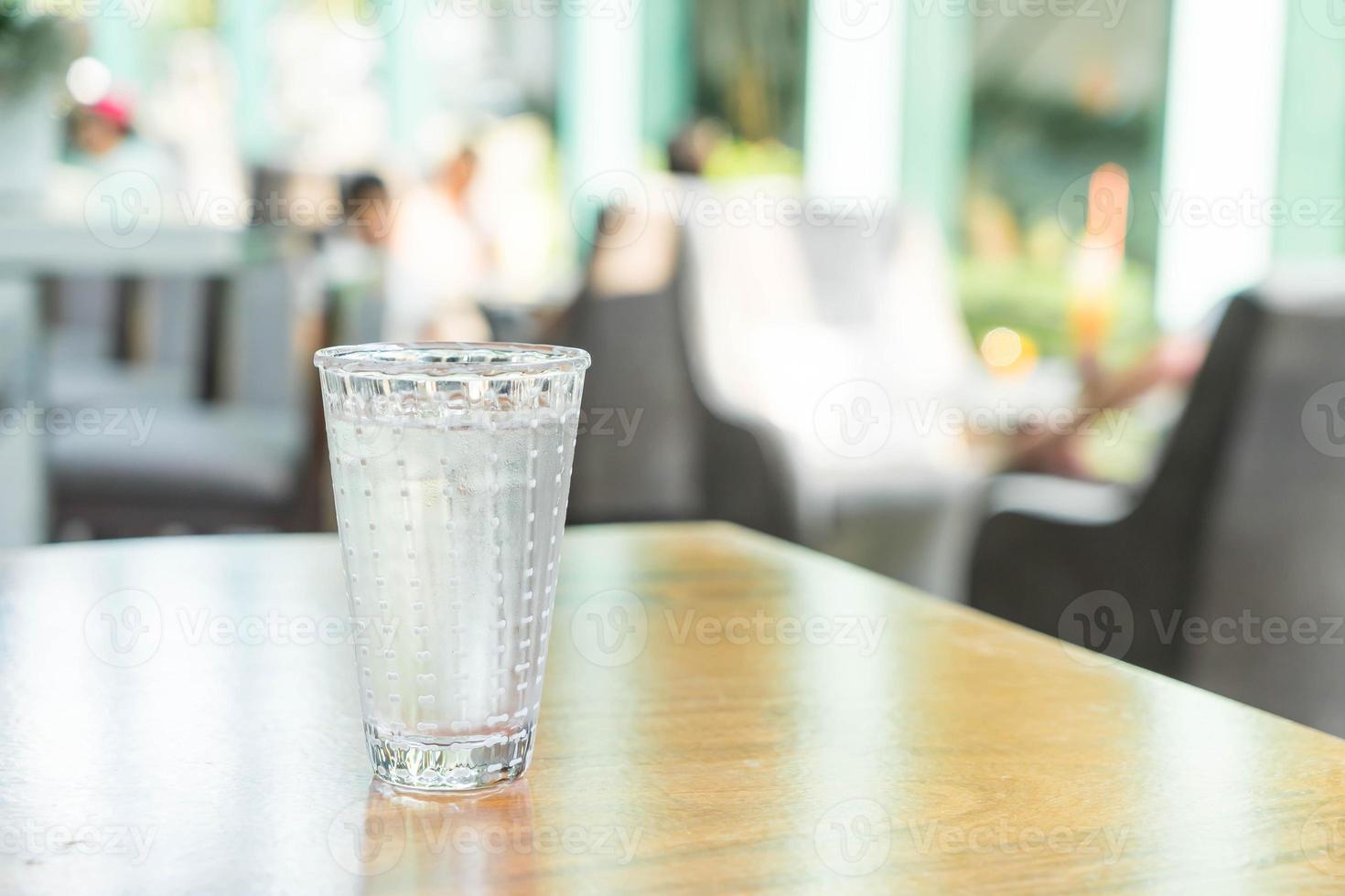 Glass of water on the table photo