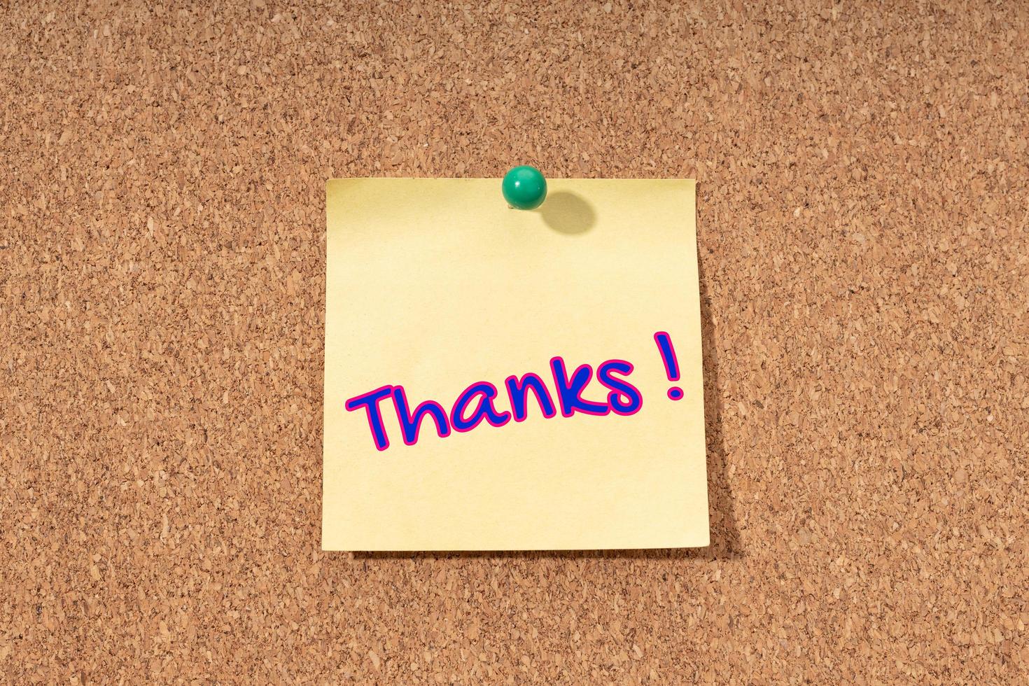 Thanks word on yellow note on cork board photo