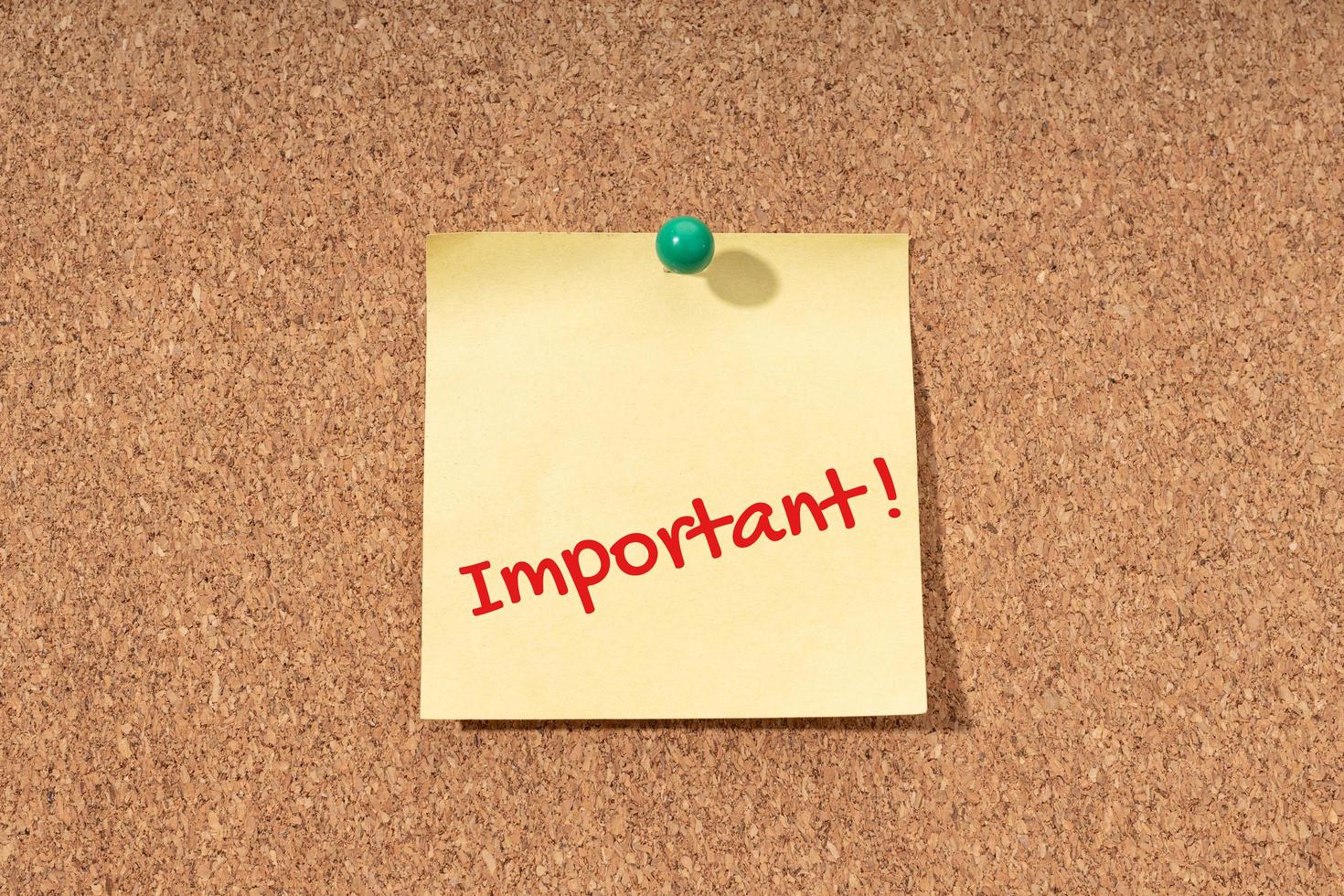 Important word on yellow note on cork board photo