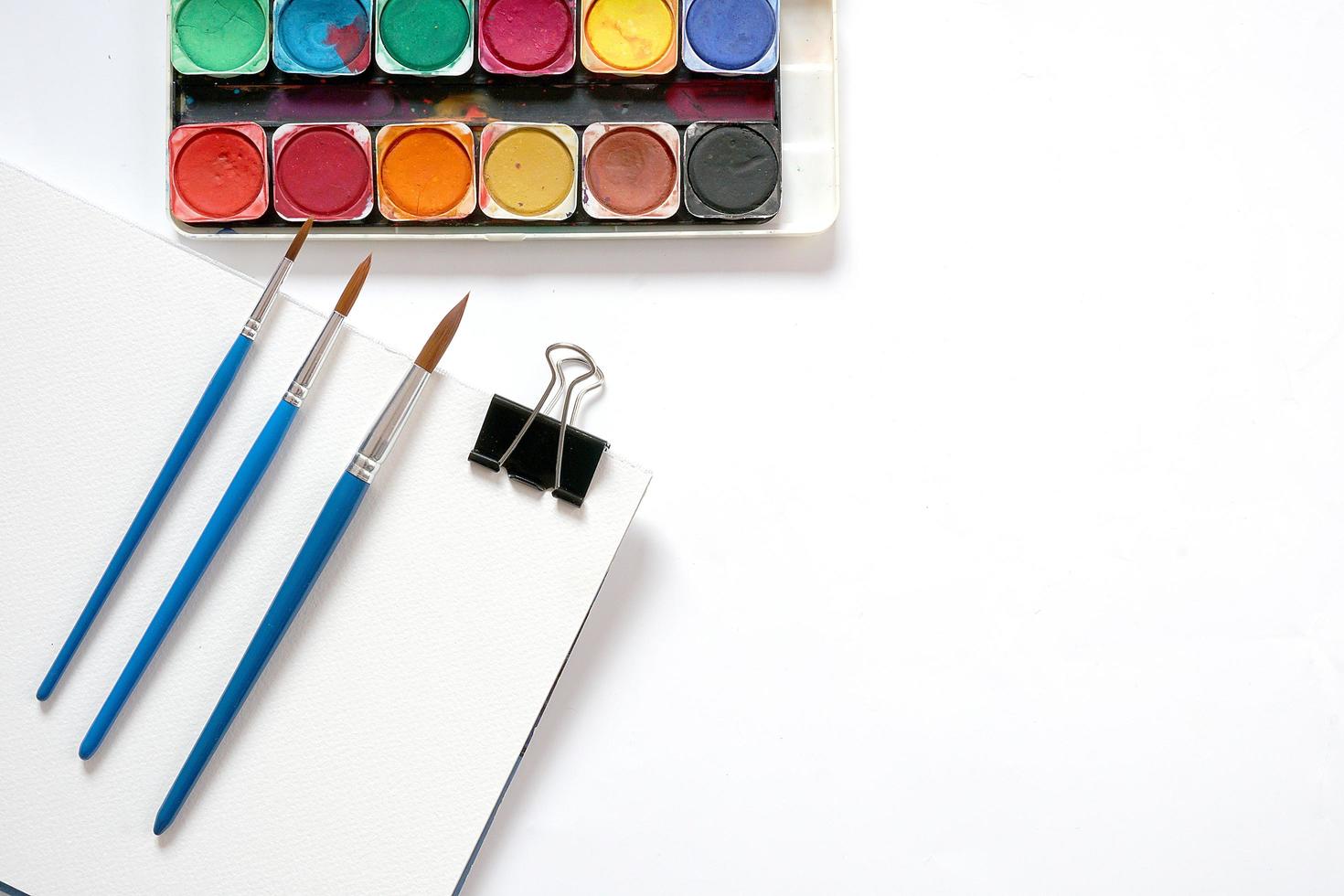 Watercolor paintbox and brushes. Flat lay, top view photo