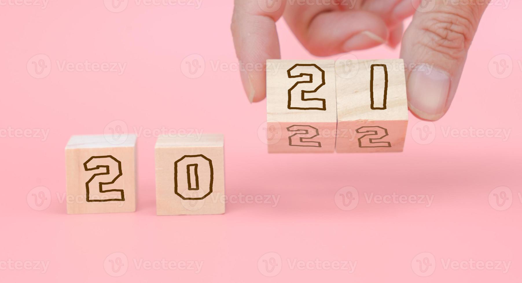 Number 2021 and 2022 on wooden block for new year.  Start new year photo
