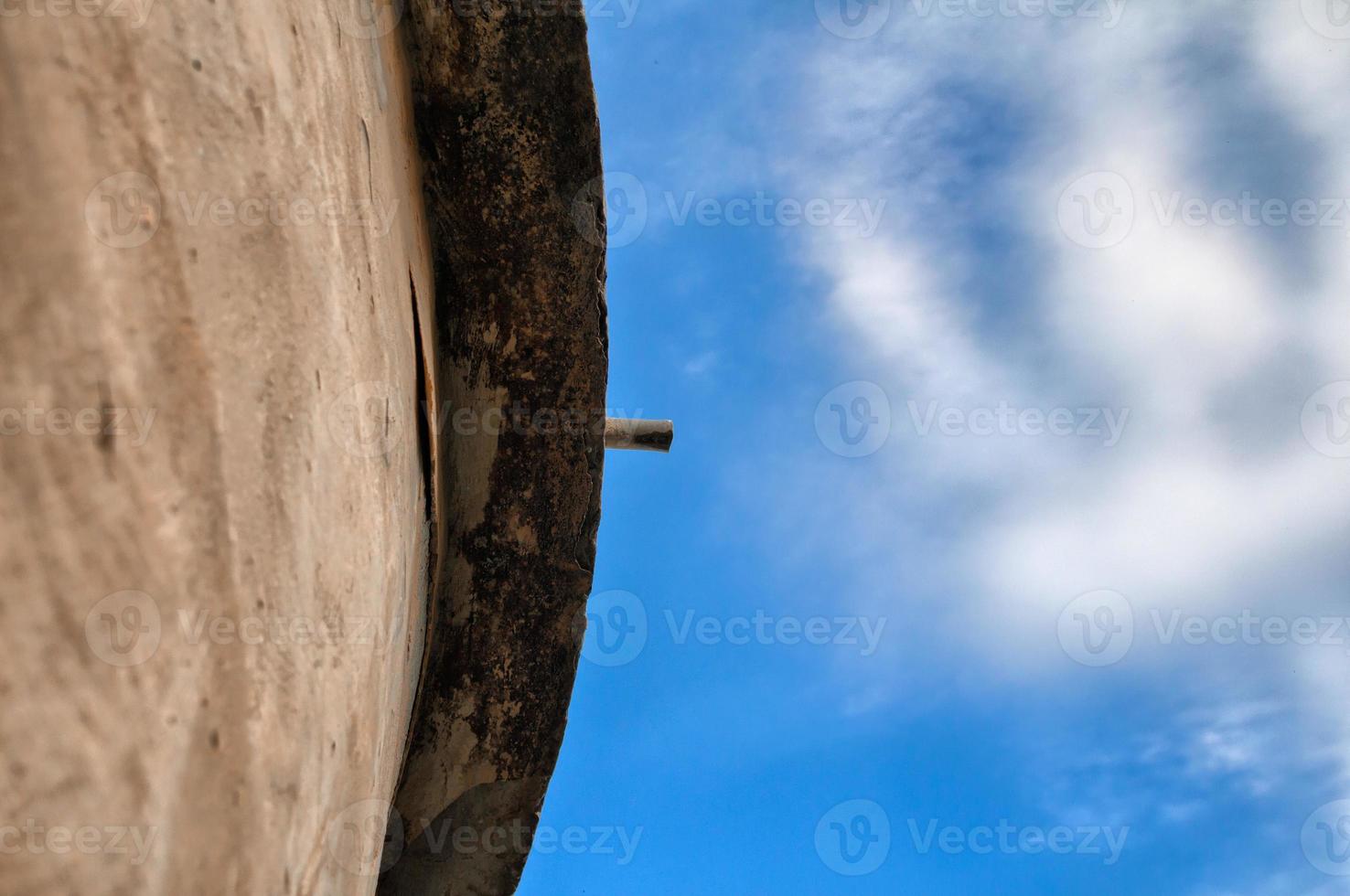 Pipe on a roof of an old building - view from below photo