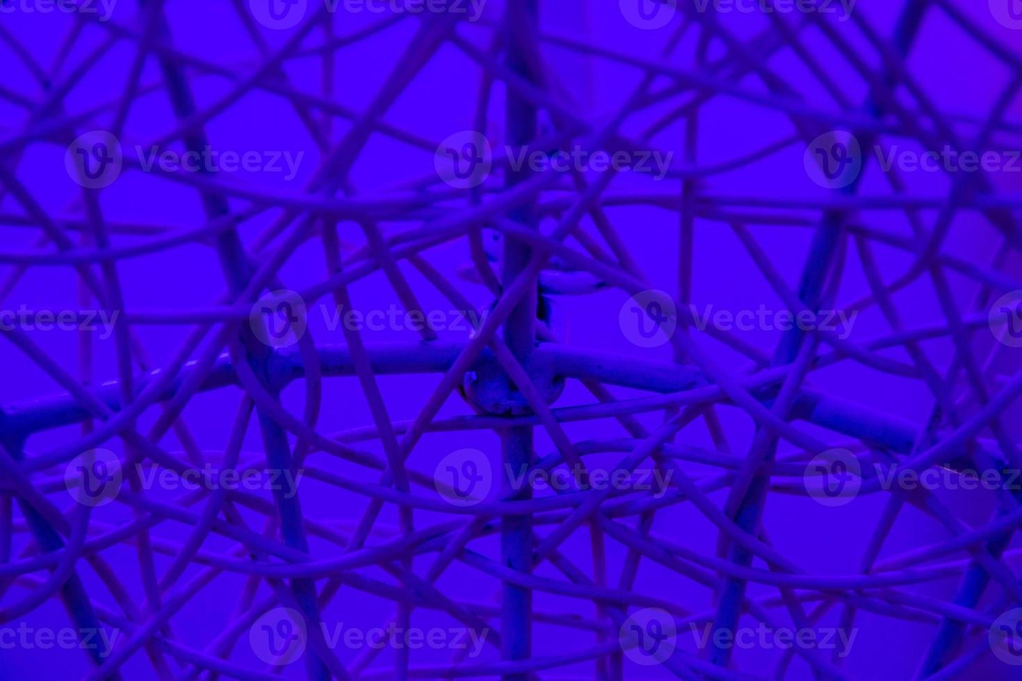 Texture of plastic rattan straw chair on color background photo