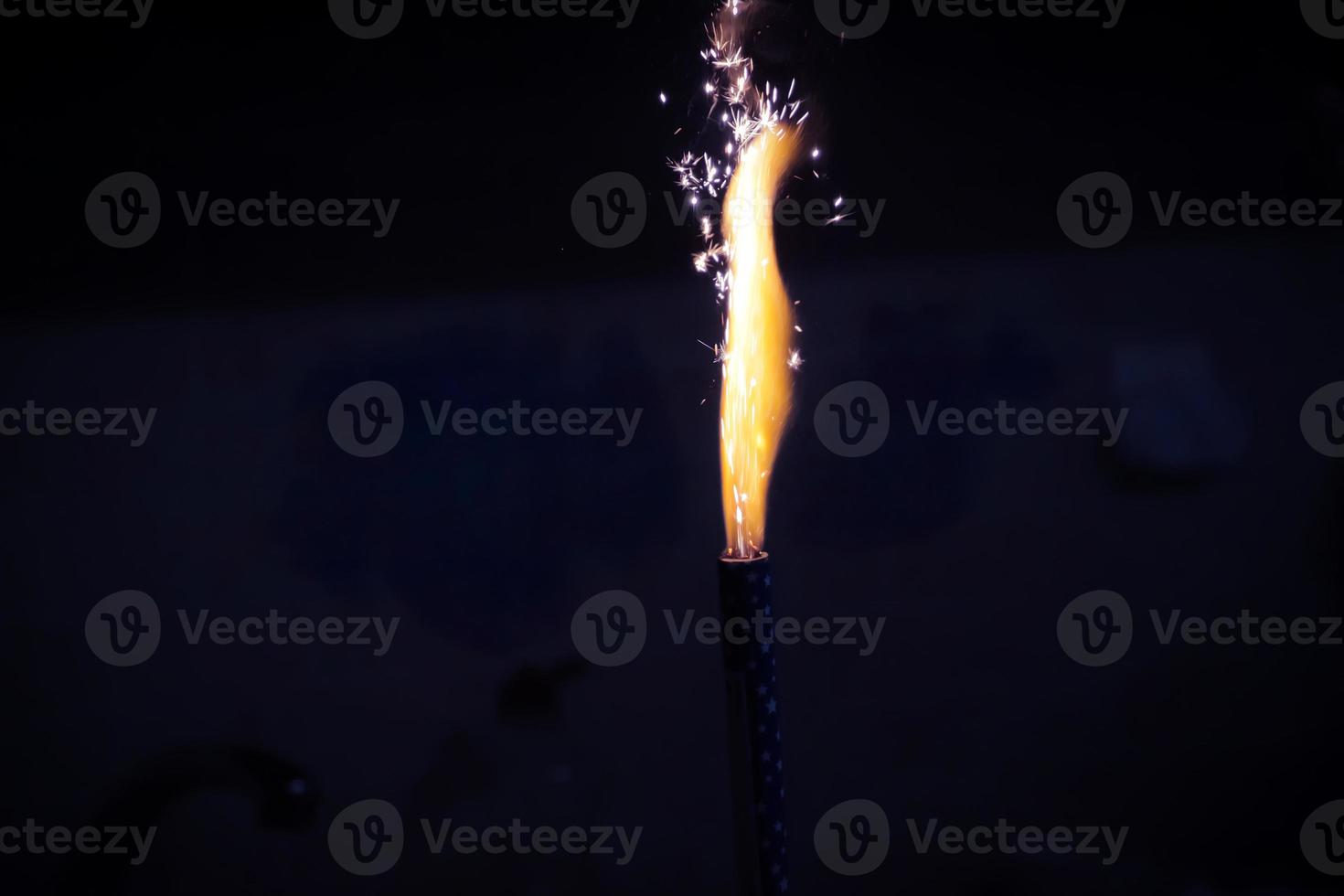 Fireworks burned in in the dark. High flame with sparks. photo