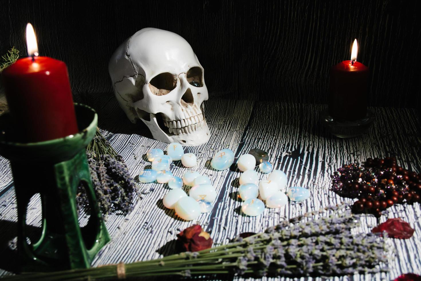 Wooden table with occult attributes, top view. Rune stones, candles. photo