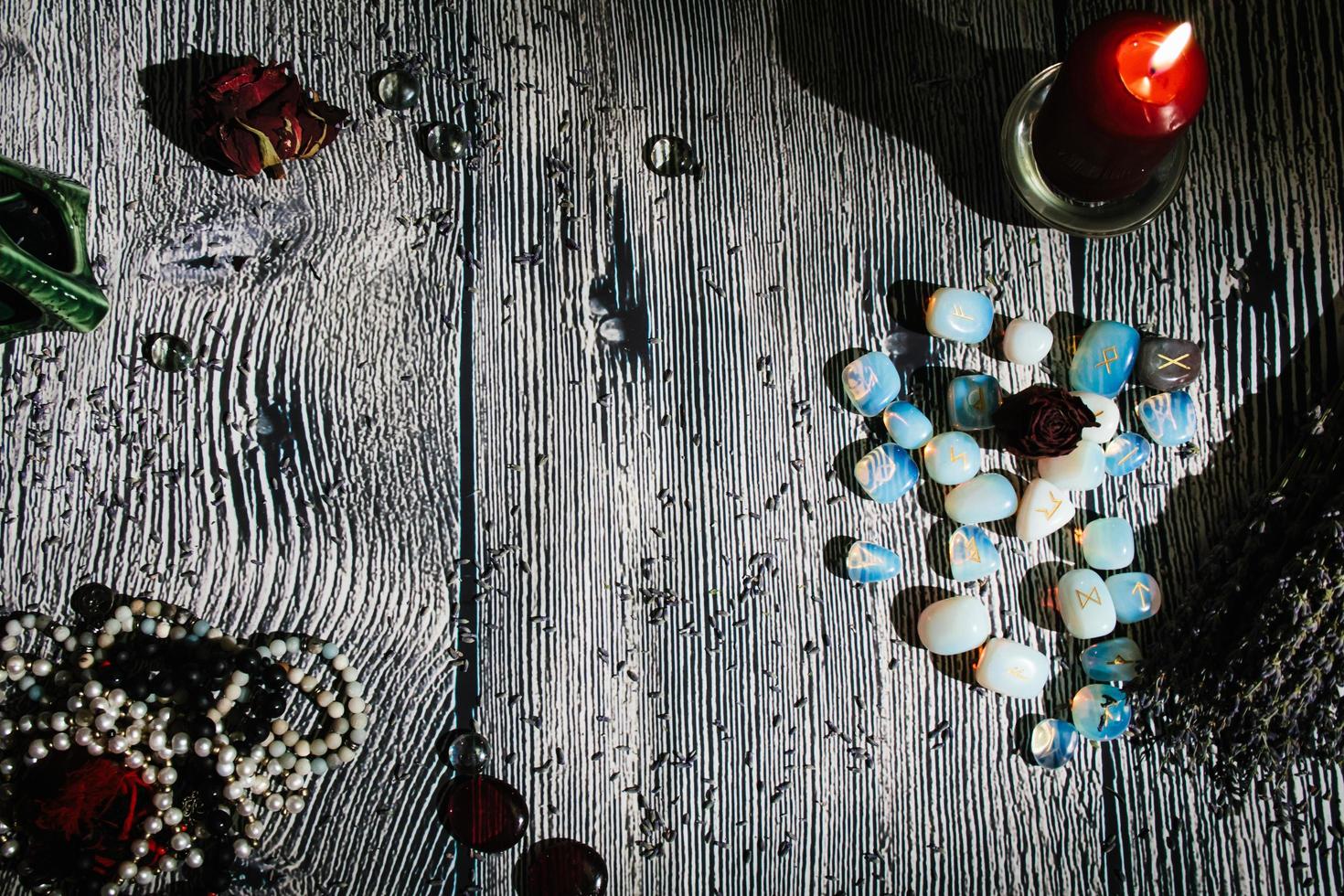 Wooden table with occult attributes, top view. Rune stones photo