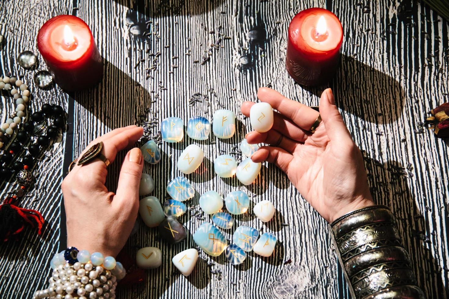 Fortuneteller's hands with stone runes, Mystic interior. photo