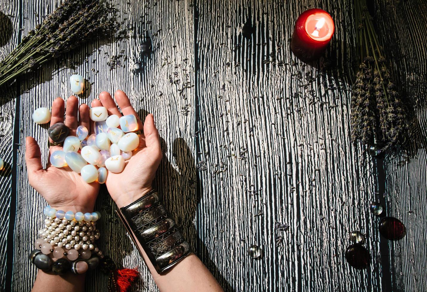 Fortuneteller's hands with stone runes, Mystic interior. photo