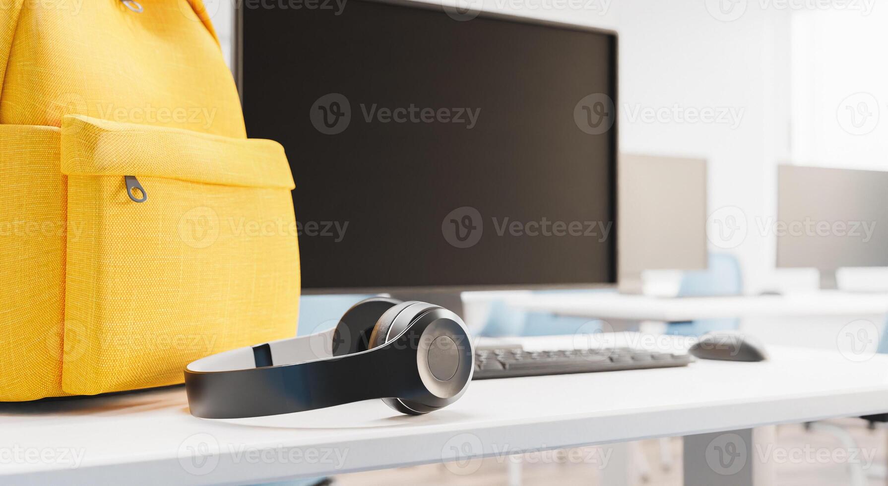 close up of headphones on a desk in a classroom photo