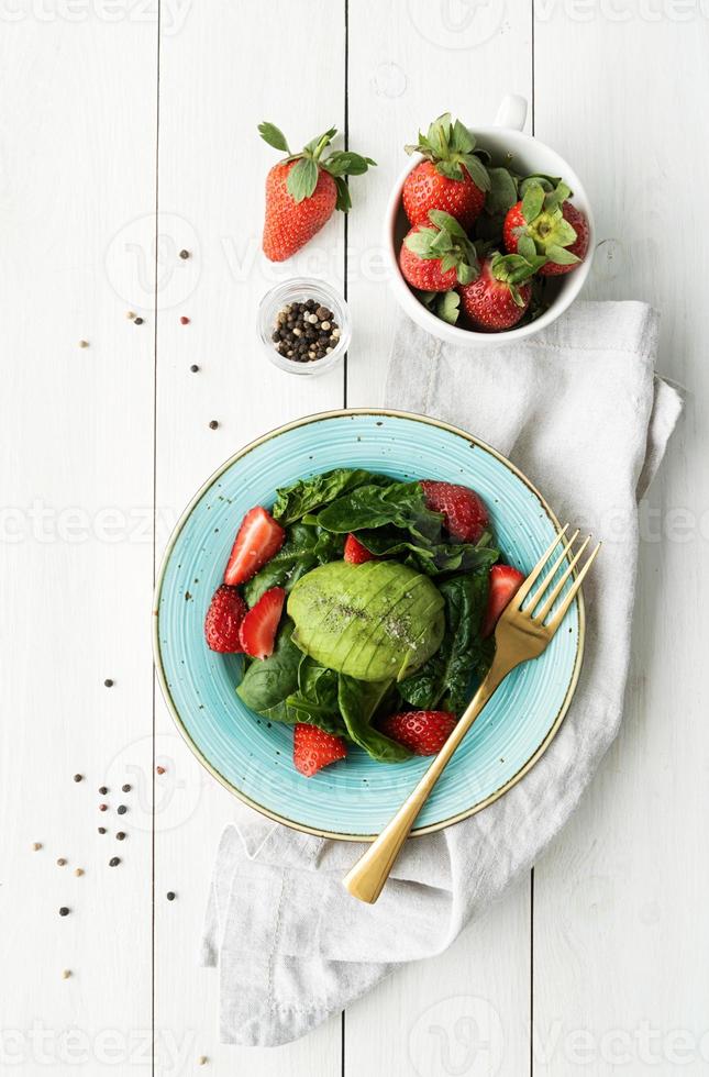 Salad with strawberries, avocados, spinach photo