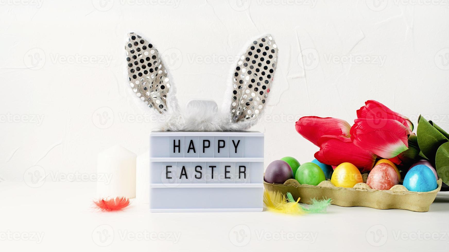 Happy Easter light box with rabbit ears and Easter decorations photo