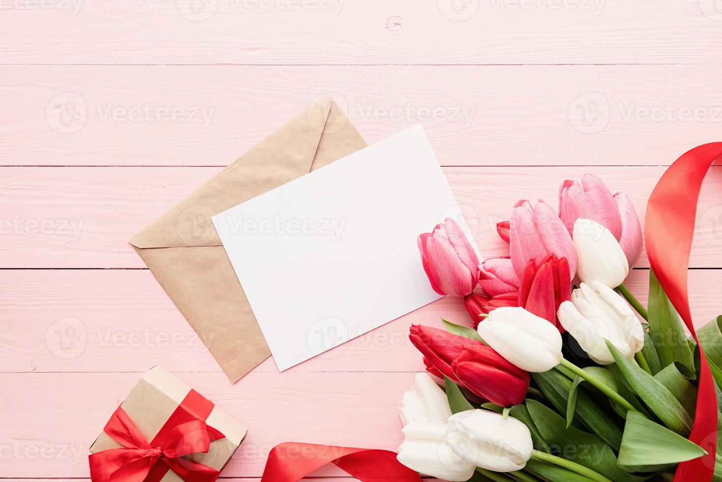Greeting card and envelope with colorful spring tulips top view photo