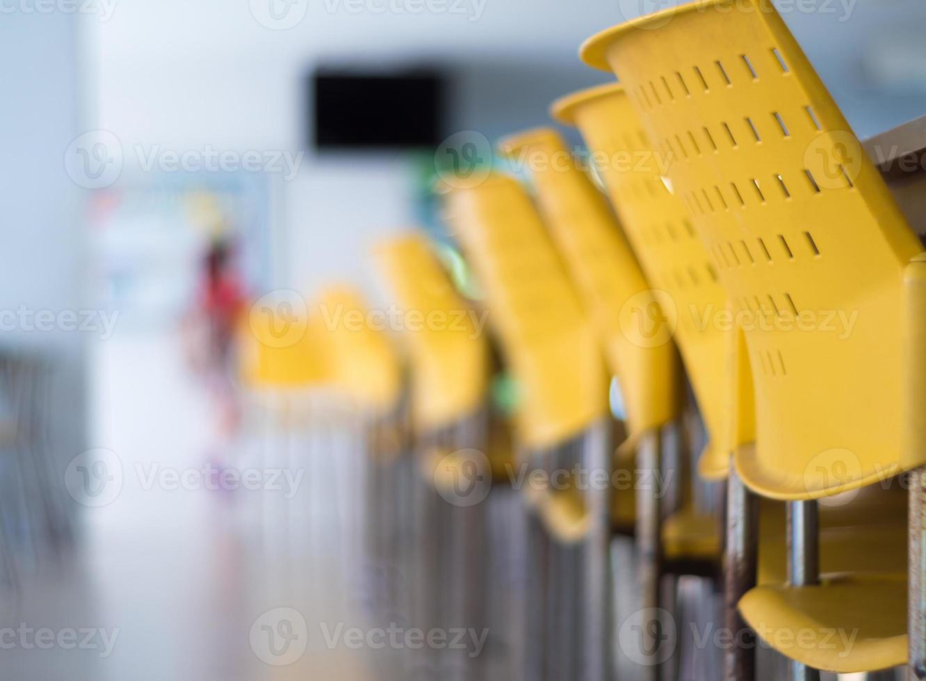 Empty tables and chairs that nobody sit in the cafeteria photo