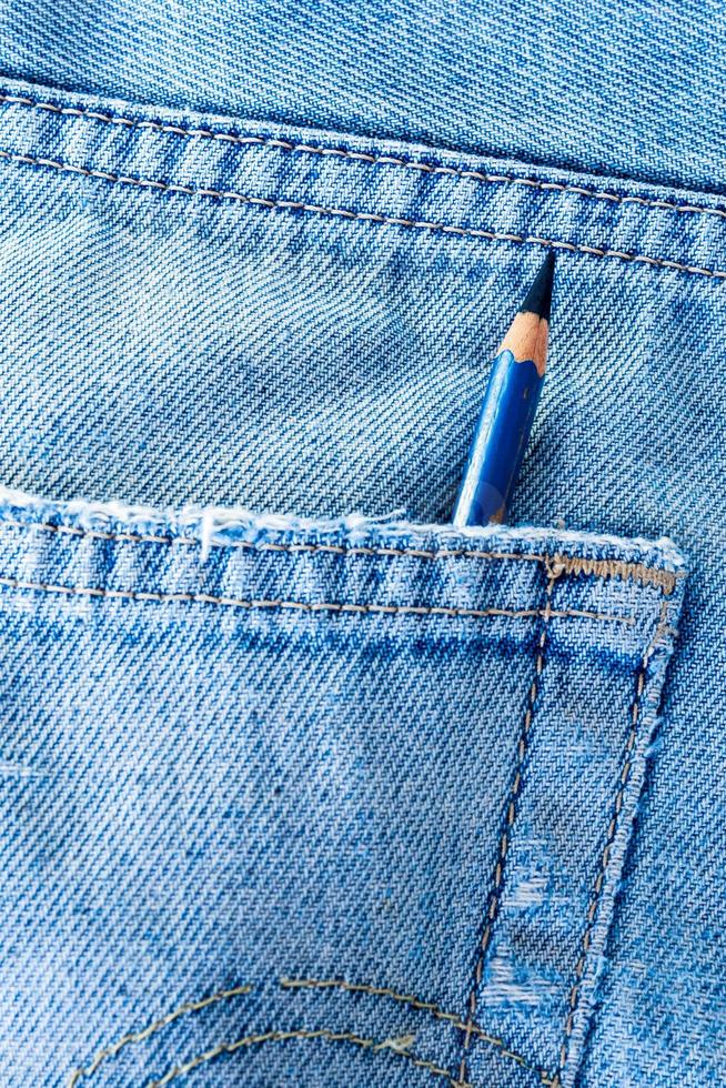 Pencil in the pocket of blue jean photo