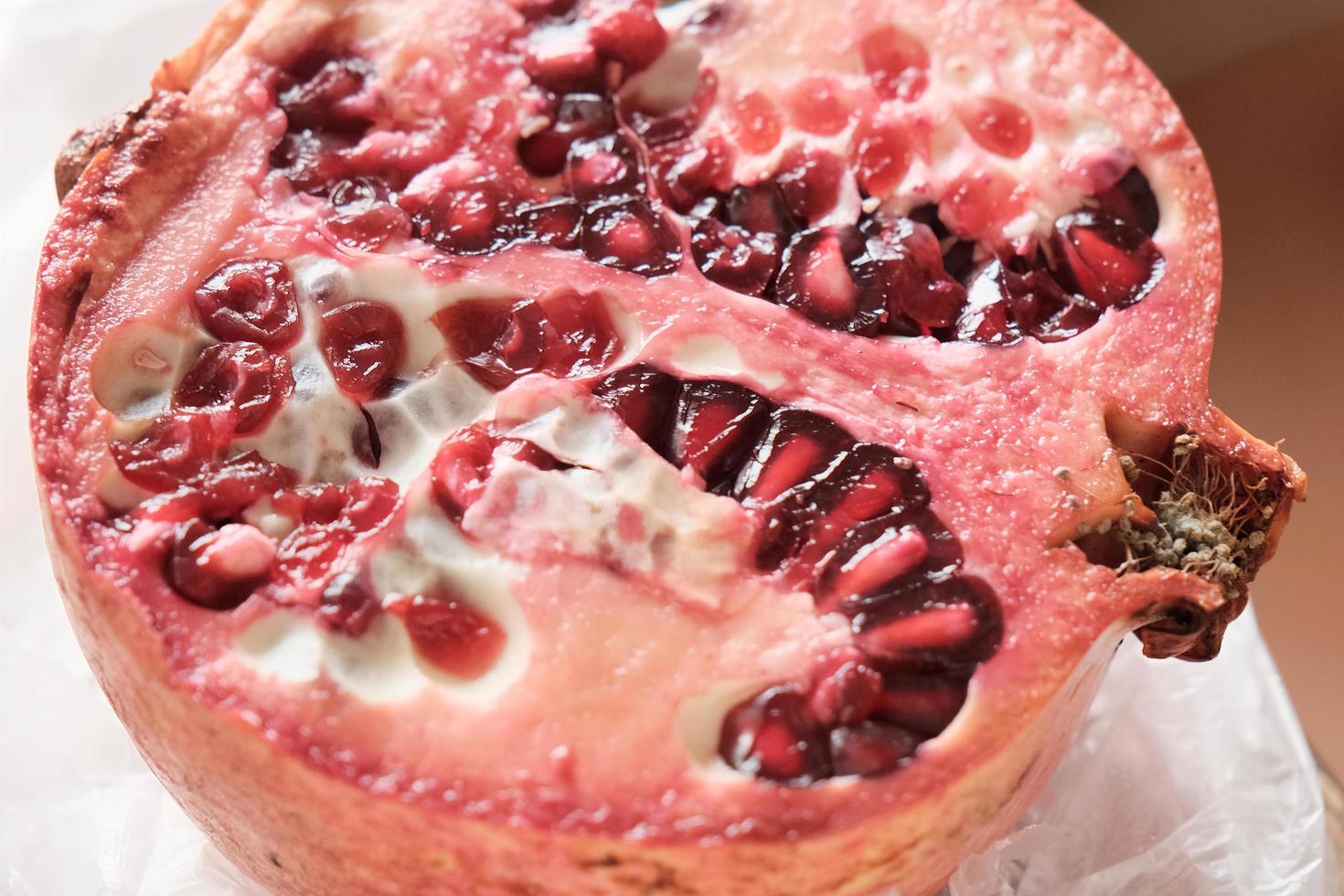 cut of ripe pomegranate, half of juicy pomegranate photo