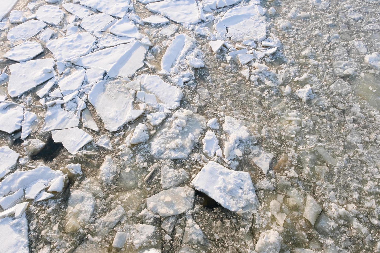 broken ice floe covered with snow with a textured surface photo