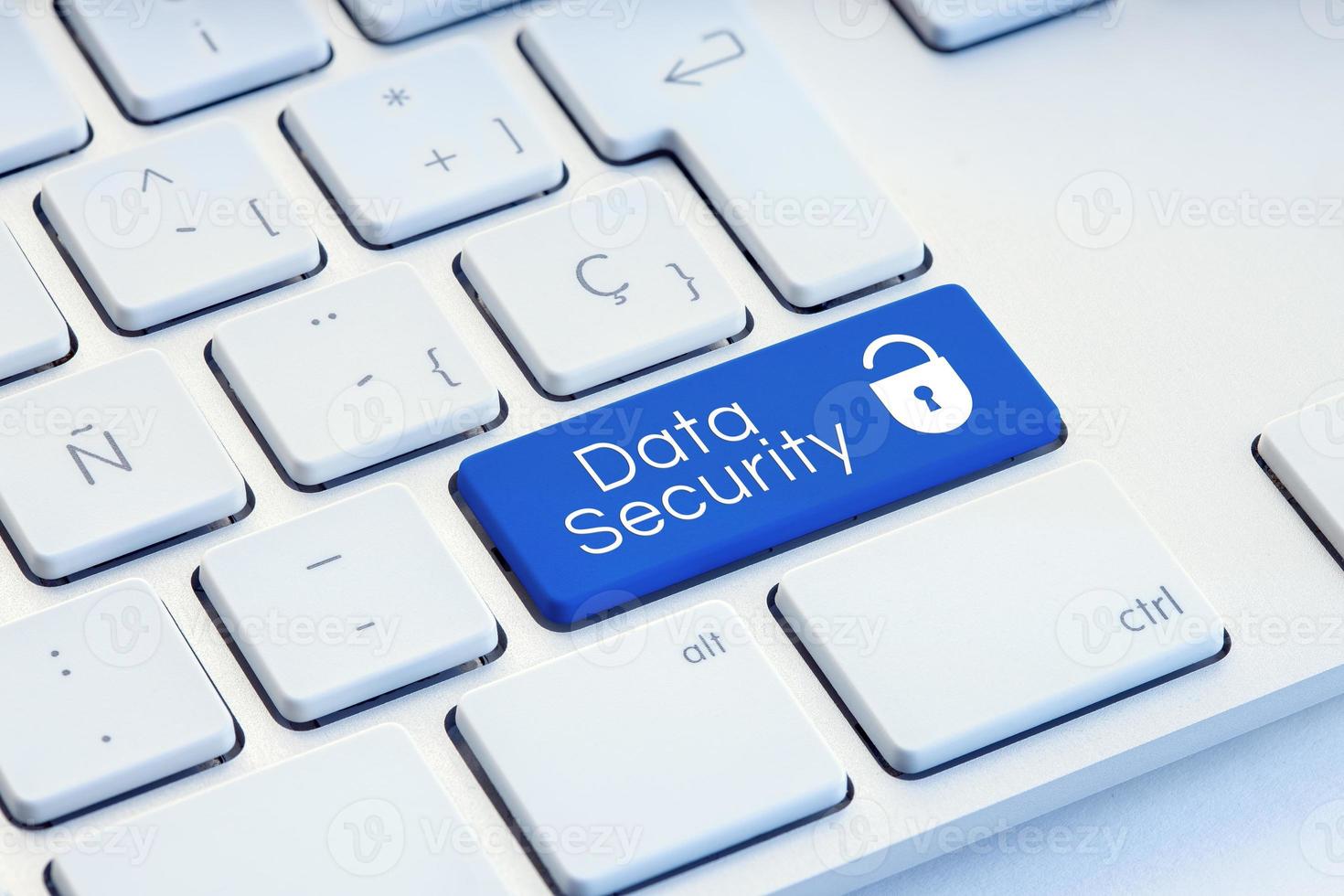 Cyber Security word and padlock icon on blue computer keyboard photo