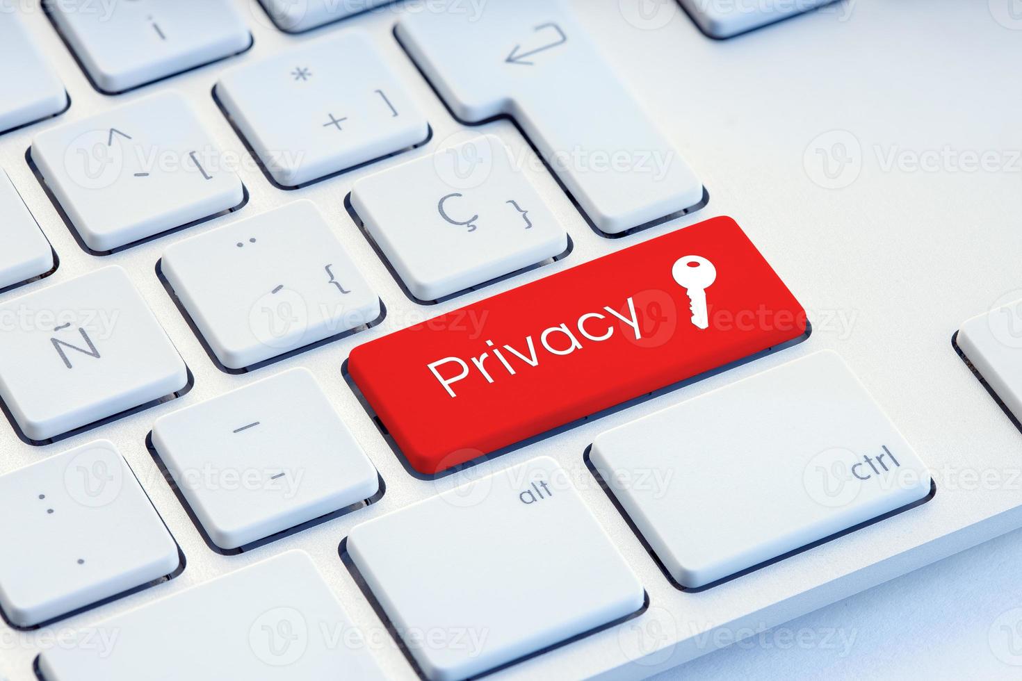 Privacy word and key icon on red computer keyboard photo