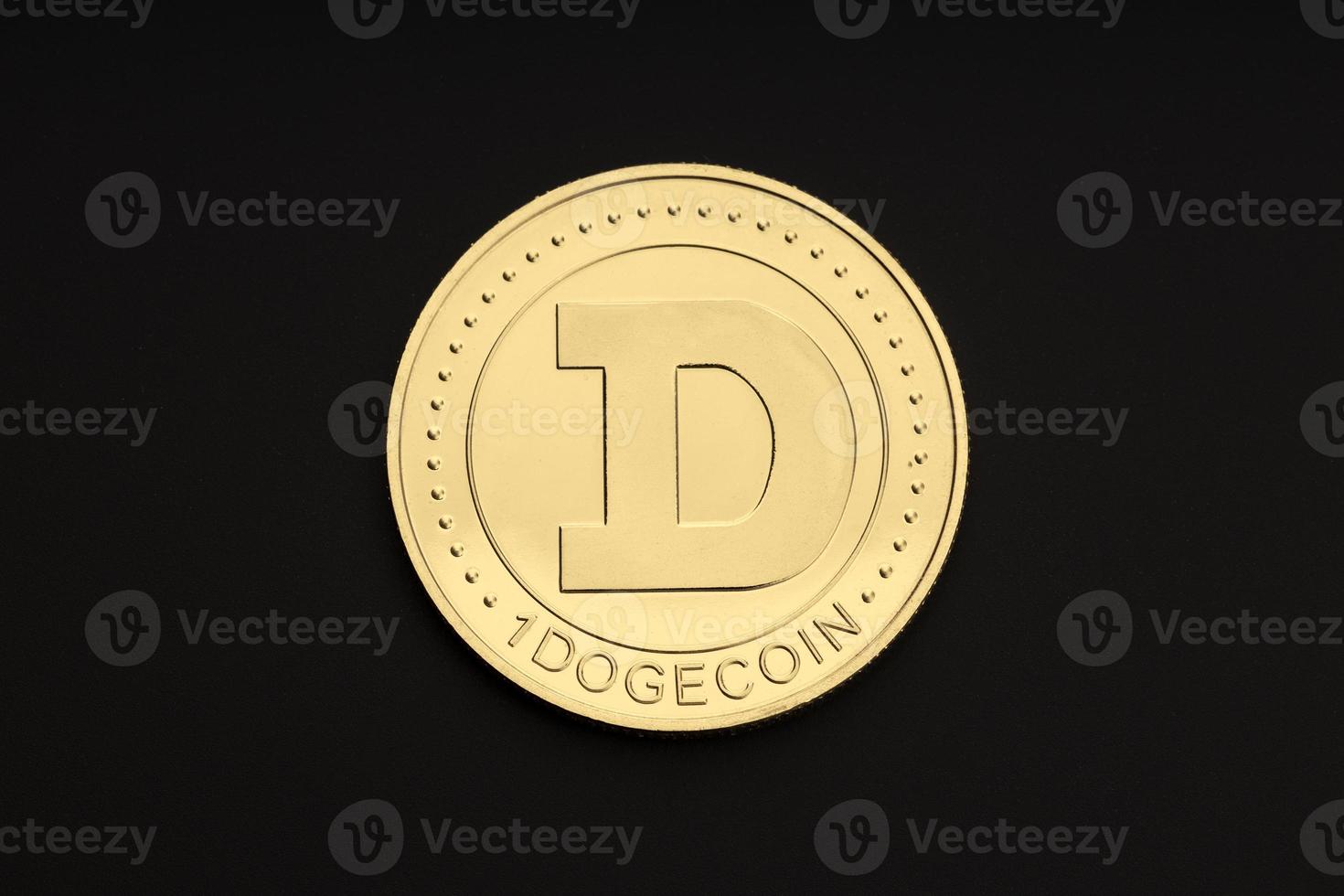 Dogecoin coin isolated on black background. Cryptocurrency. Top view photo