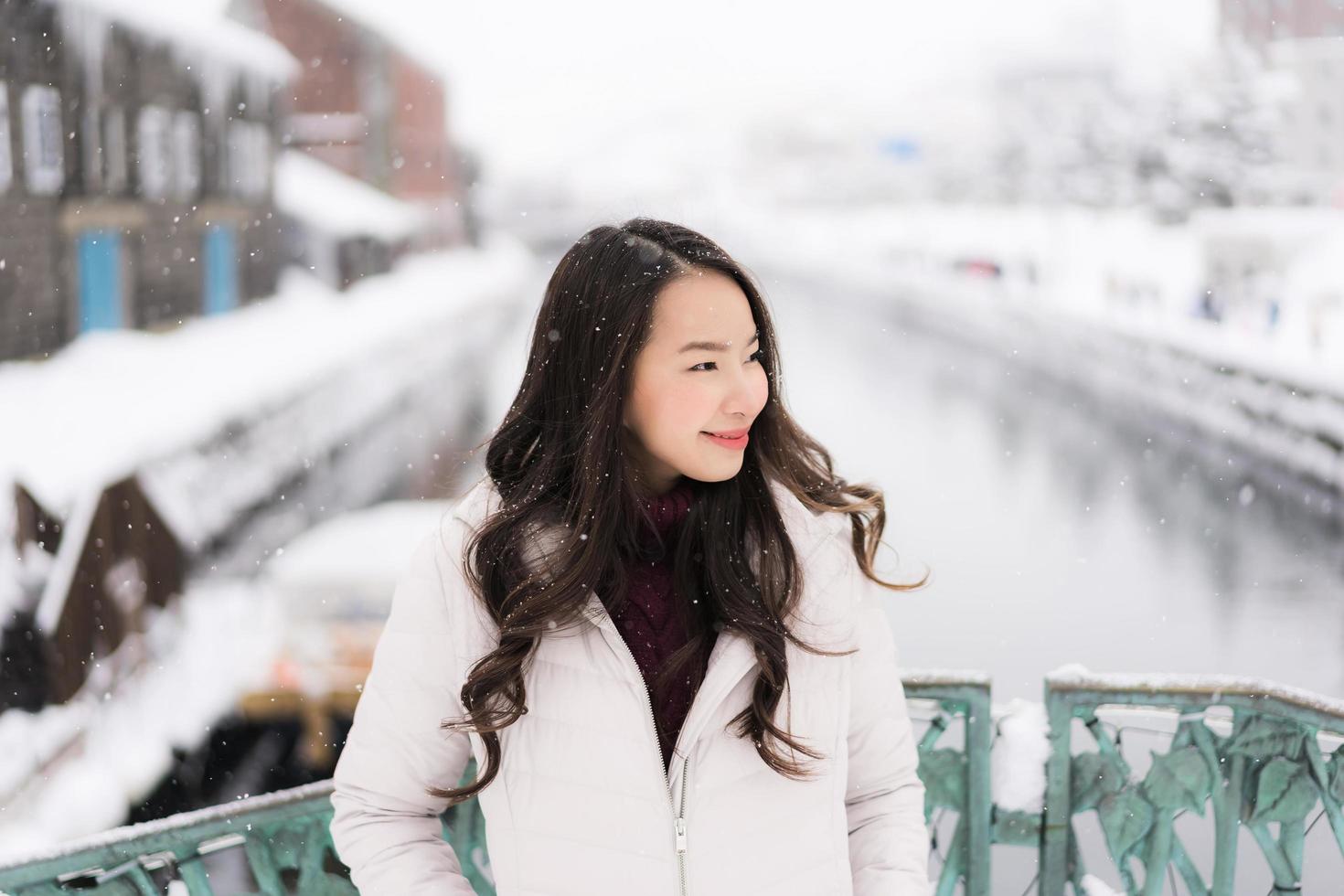 asian woman smiling happy for travel in snow winter season photo