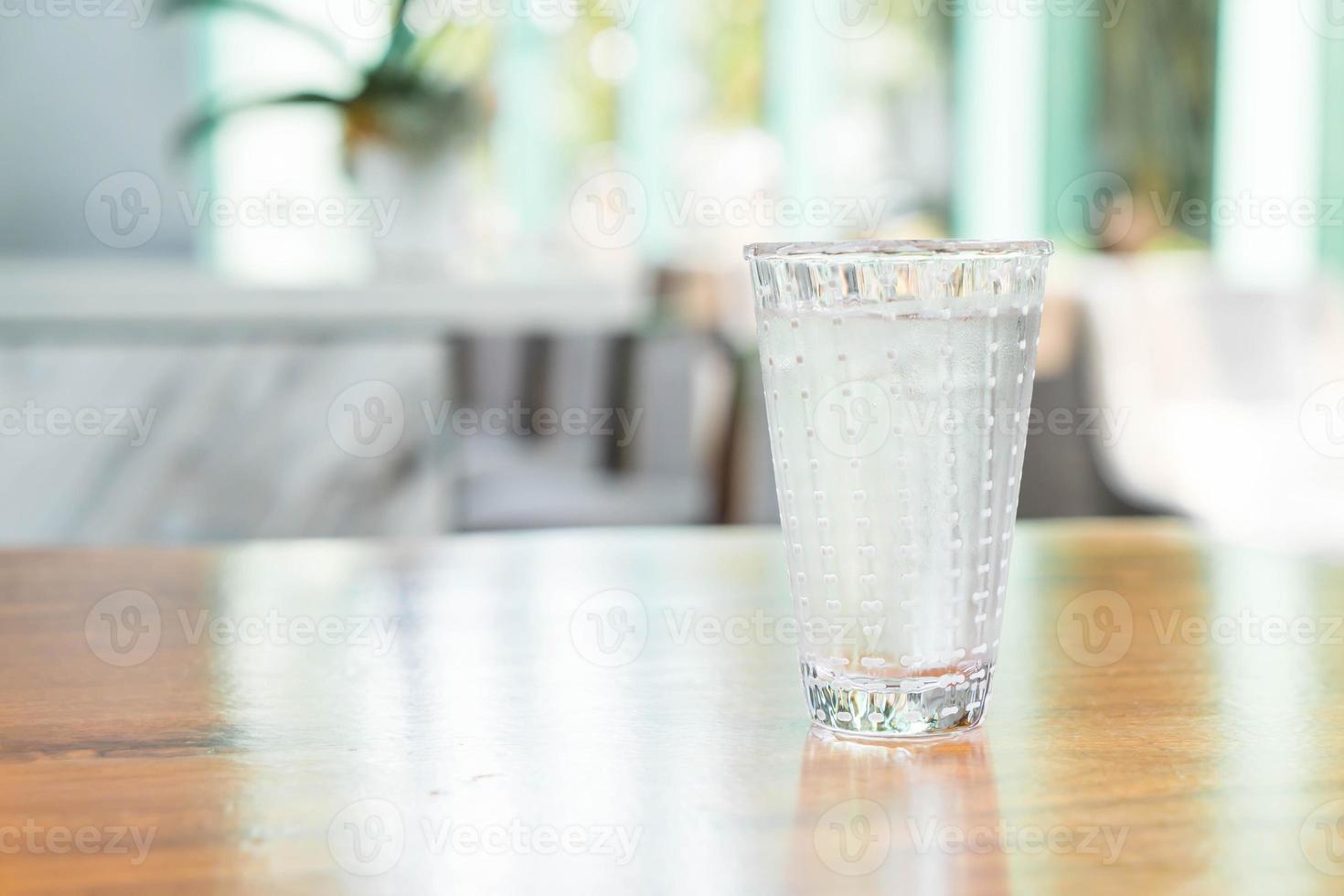 Glass of water on the table photo