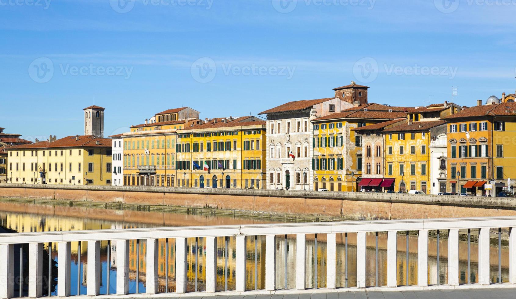 Old buildings in Pisa reflected in the Arno River photo