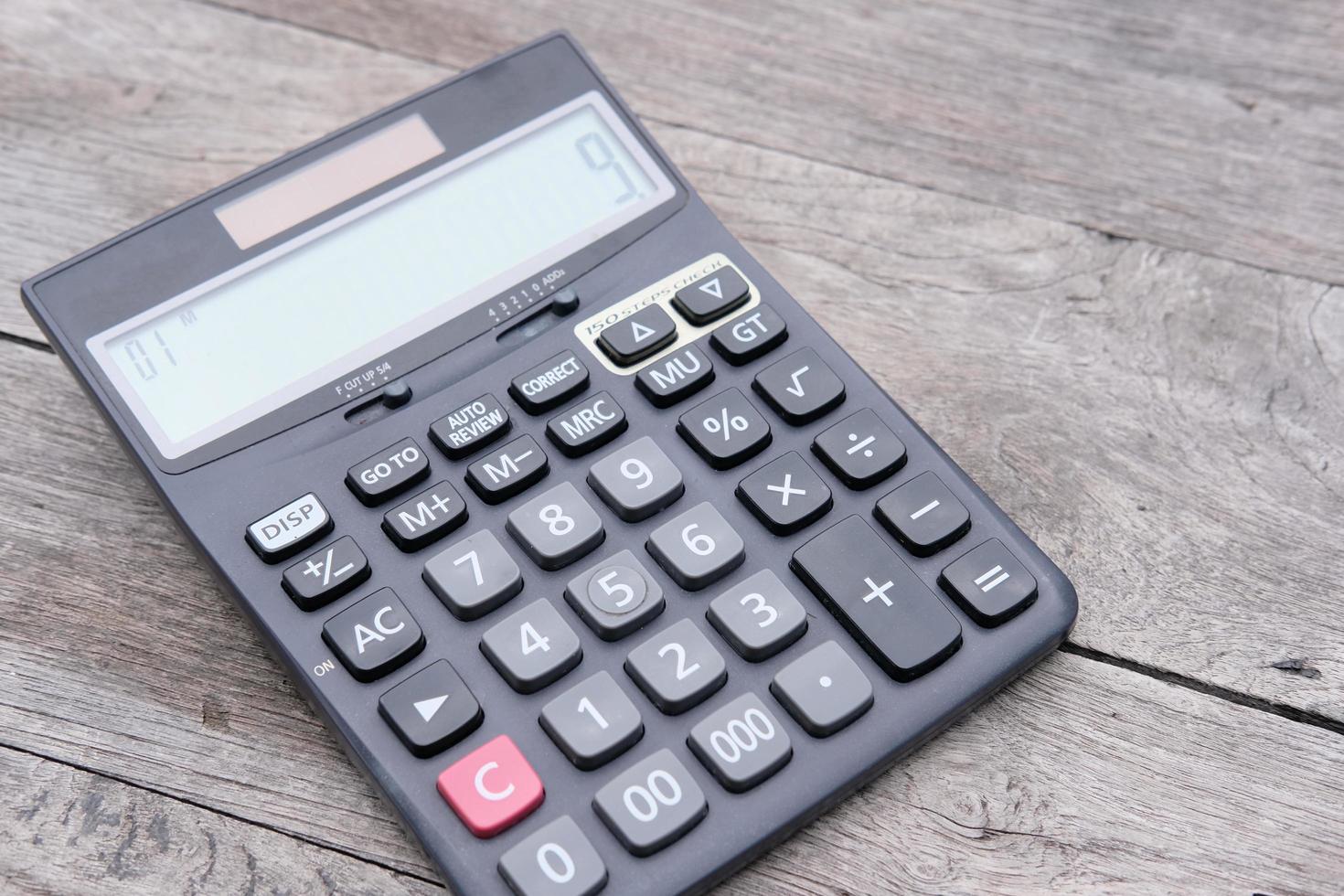 Close up calculator on wood table photo