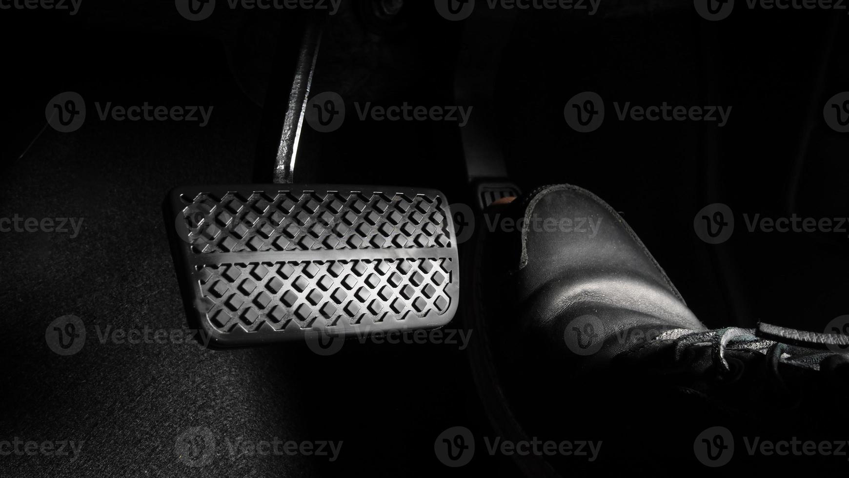 Man foot and accelerator and brake pedal inside the car photo