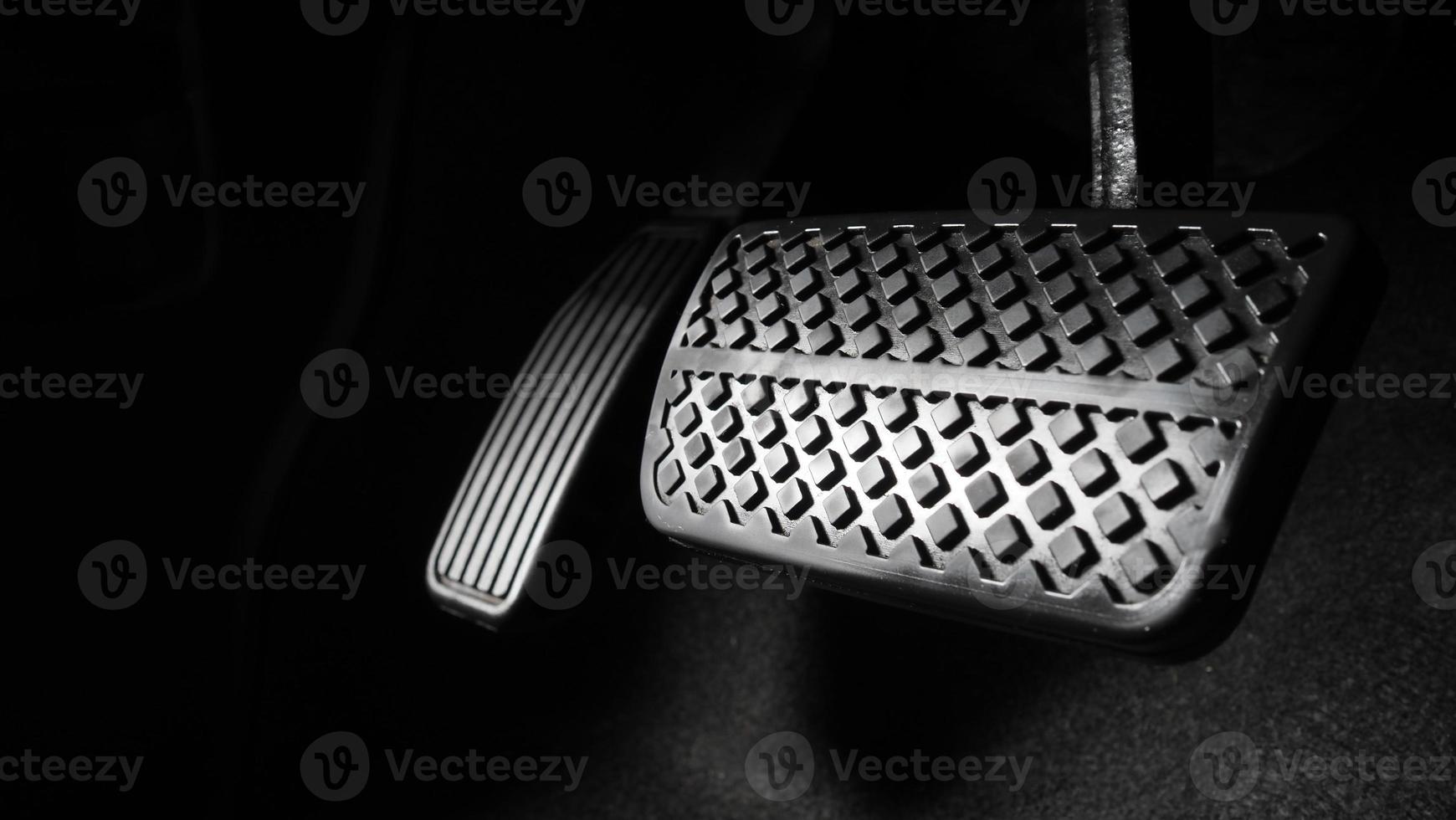 Man foot and accelerator and brake pedal inside the car photo