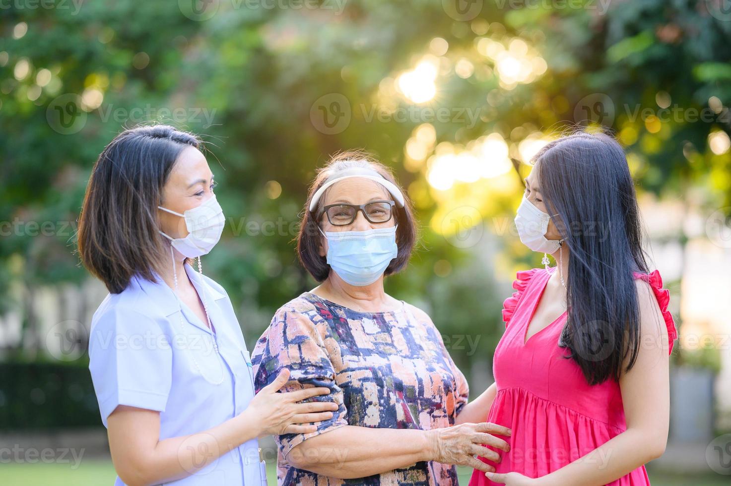 Happy senior Asian woman with caregiver photo