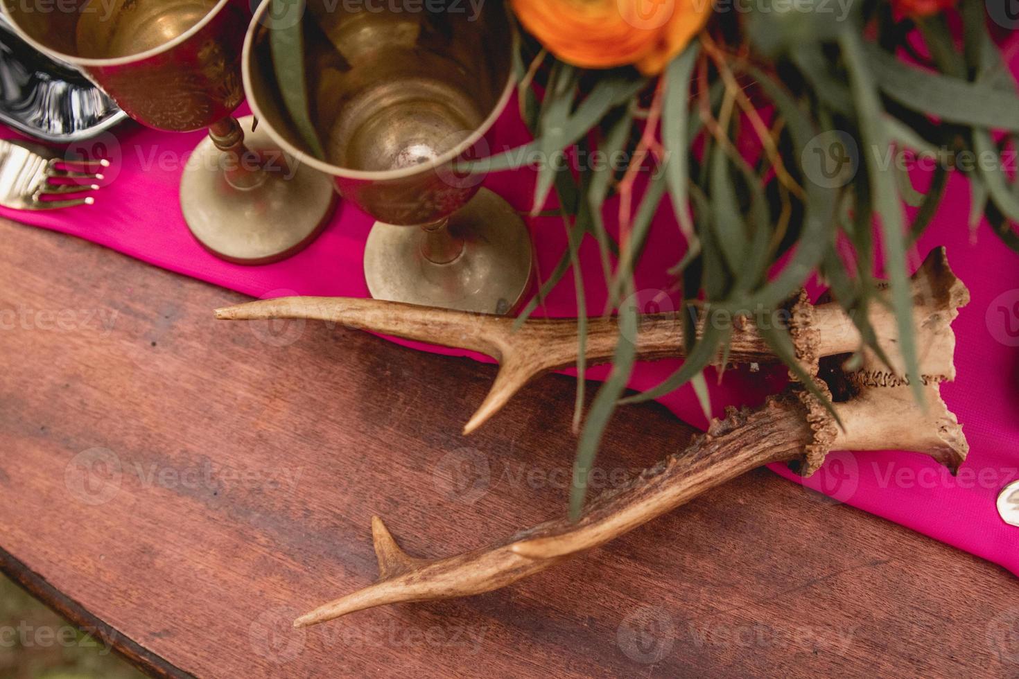 Decorated wooden table with flowers, candles, utensils photo