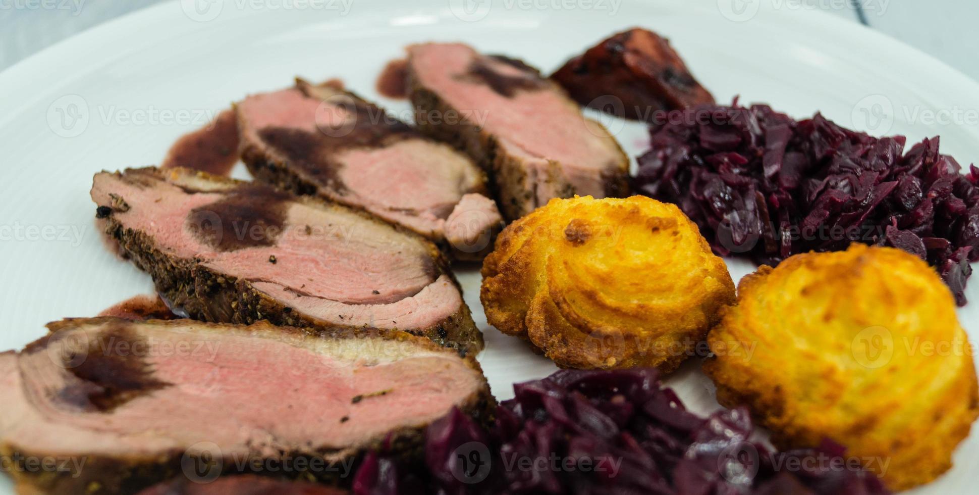 Fried duck breast with red  cabbage and croquettes photo