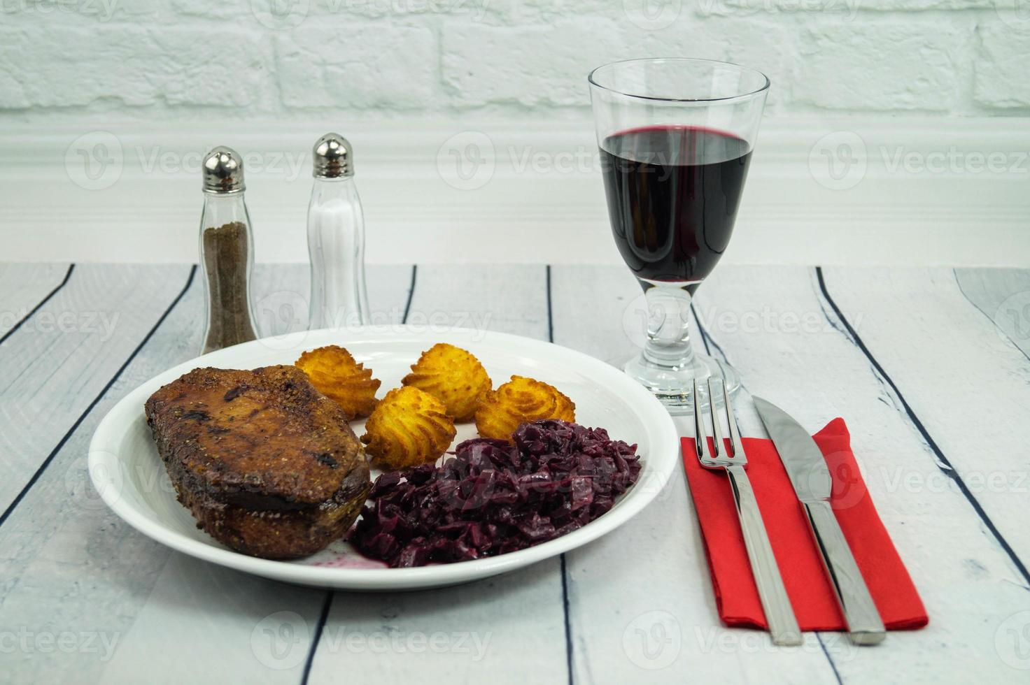 Fried duck breast with red  cabbage and croquettes photo