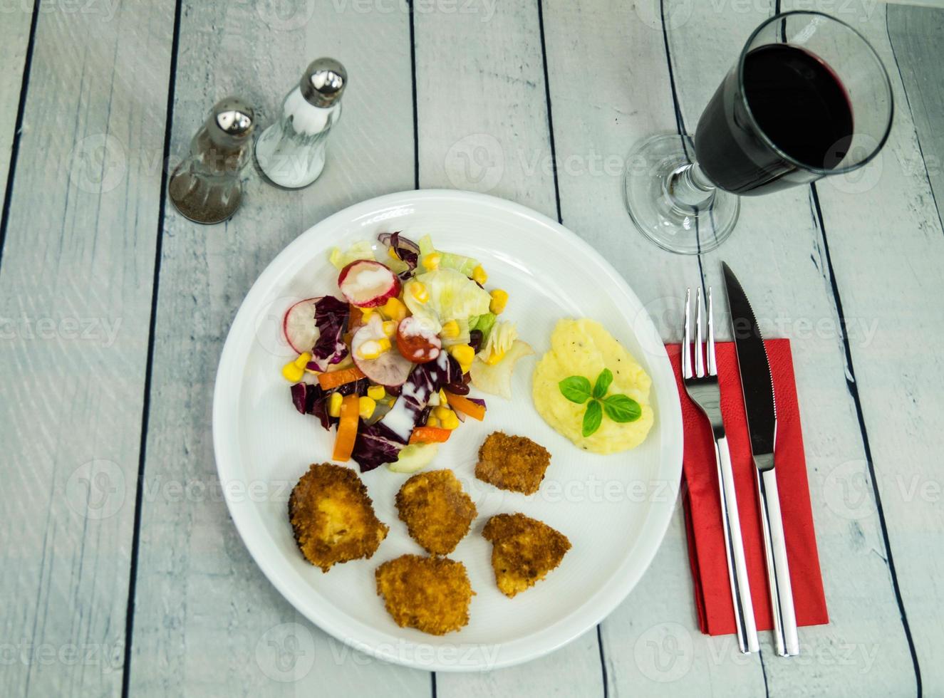 Golden fried chicken Nuggets with salad photo