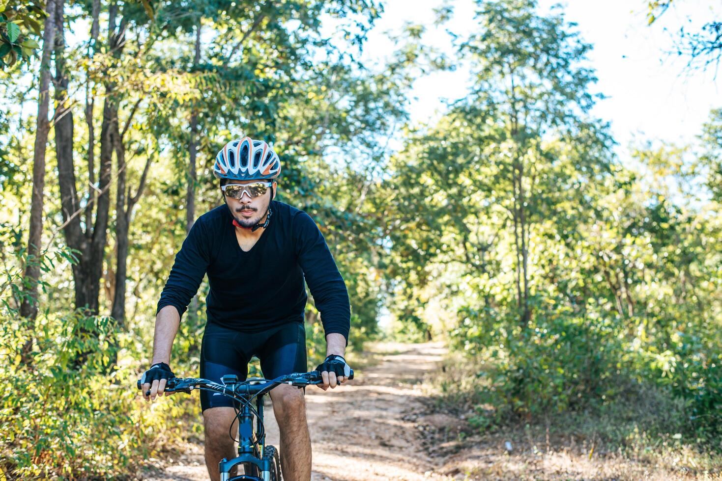 Cyclist Riding the Bike on the Beautiful Spring Mountain Trail photo