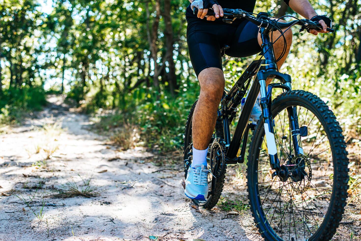 The man riding a bike in a mountain path photo