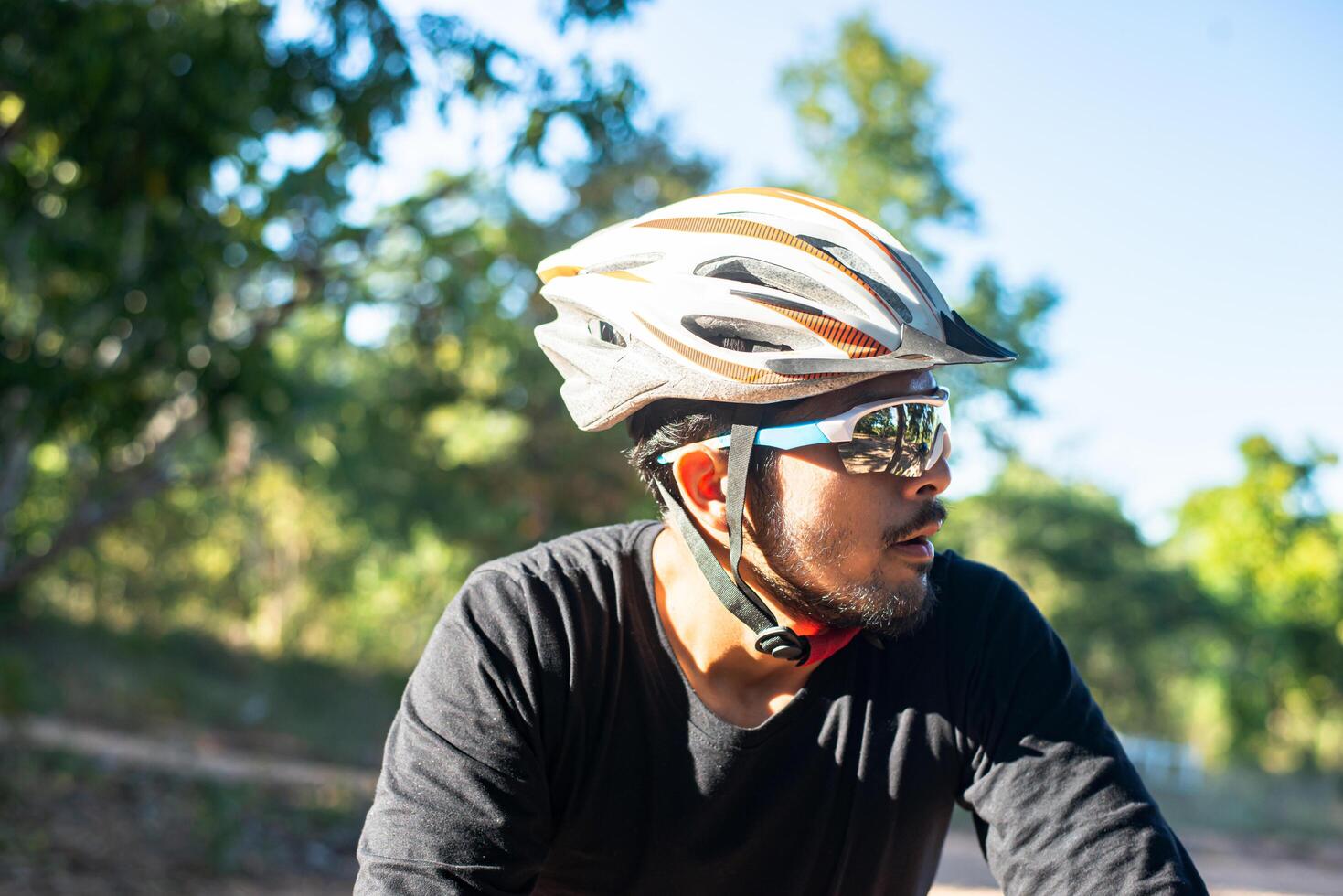 Mountain cyclists sit on bicycles and look to the left. photo