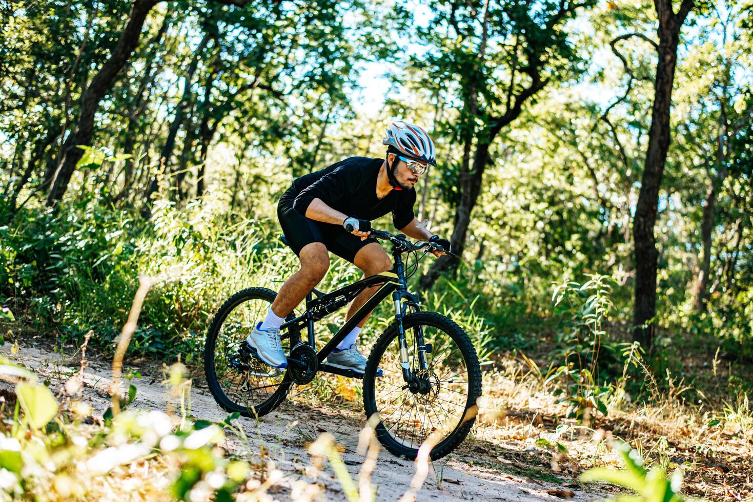 Cyclist Riding the Bike on the Beautiful Spring Mountain Trail photo