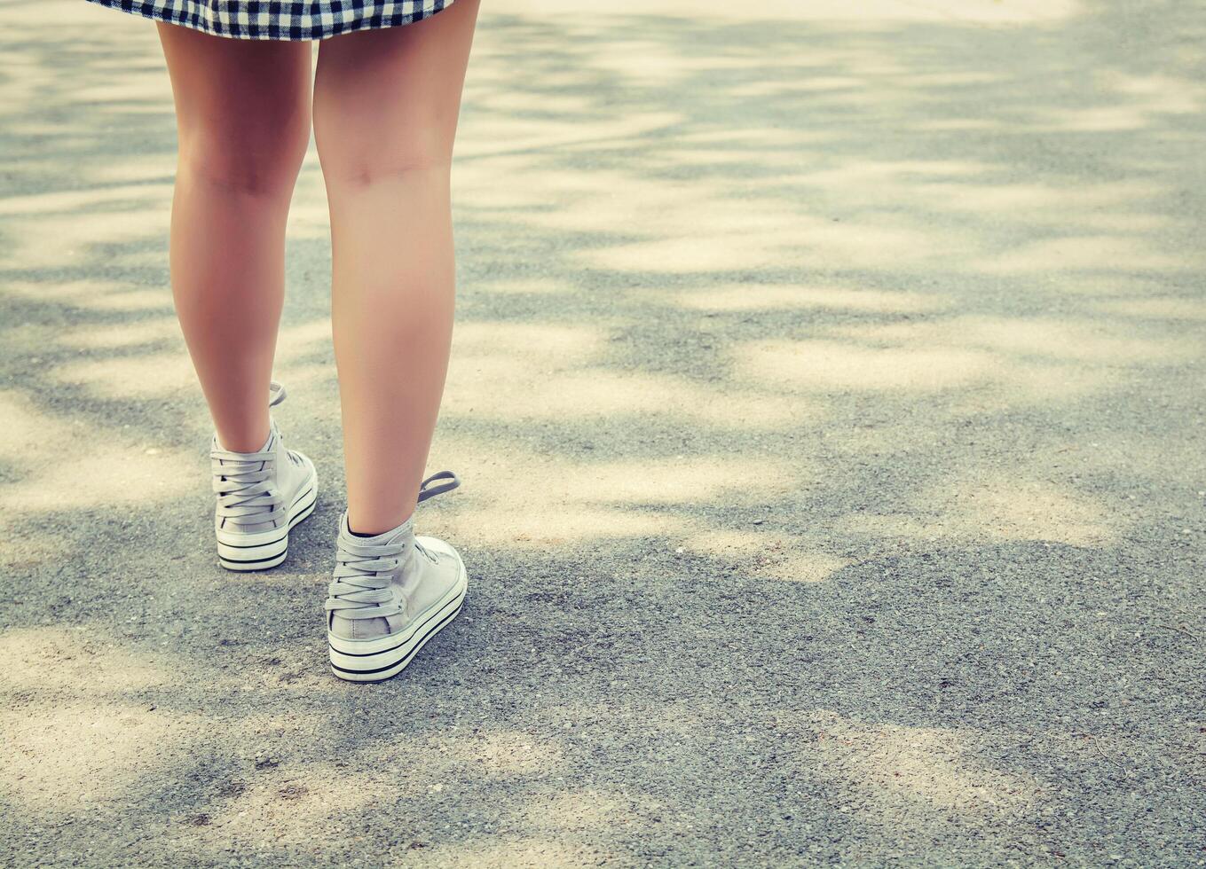 Woman feets walking in the park photo