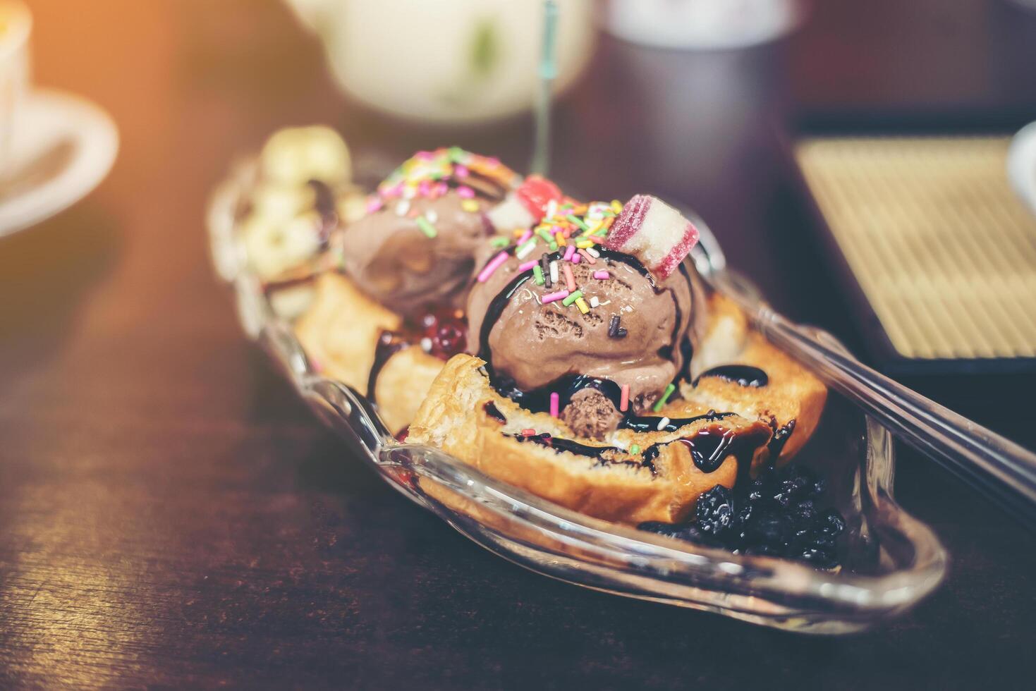 Banana split sunday ice cream in a bowl with strawberry. photo