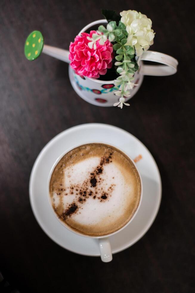 Top view cup of cappuccino on wooden table background. photo