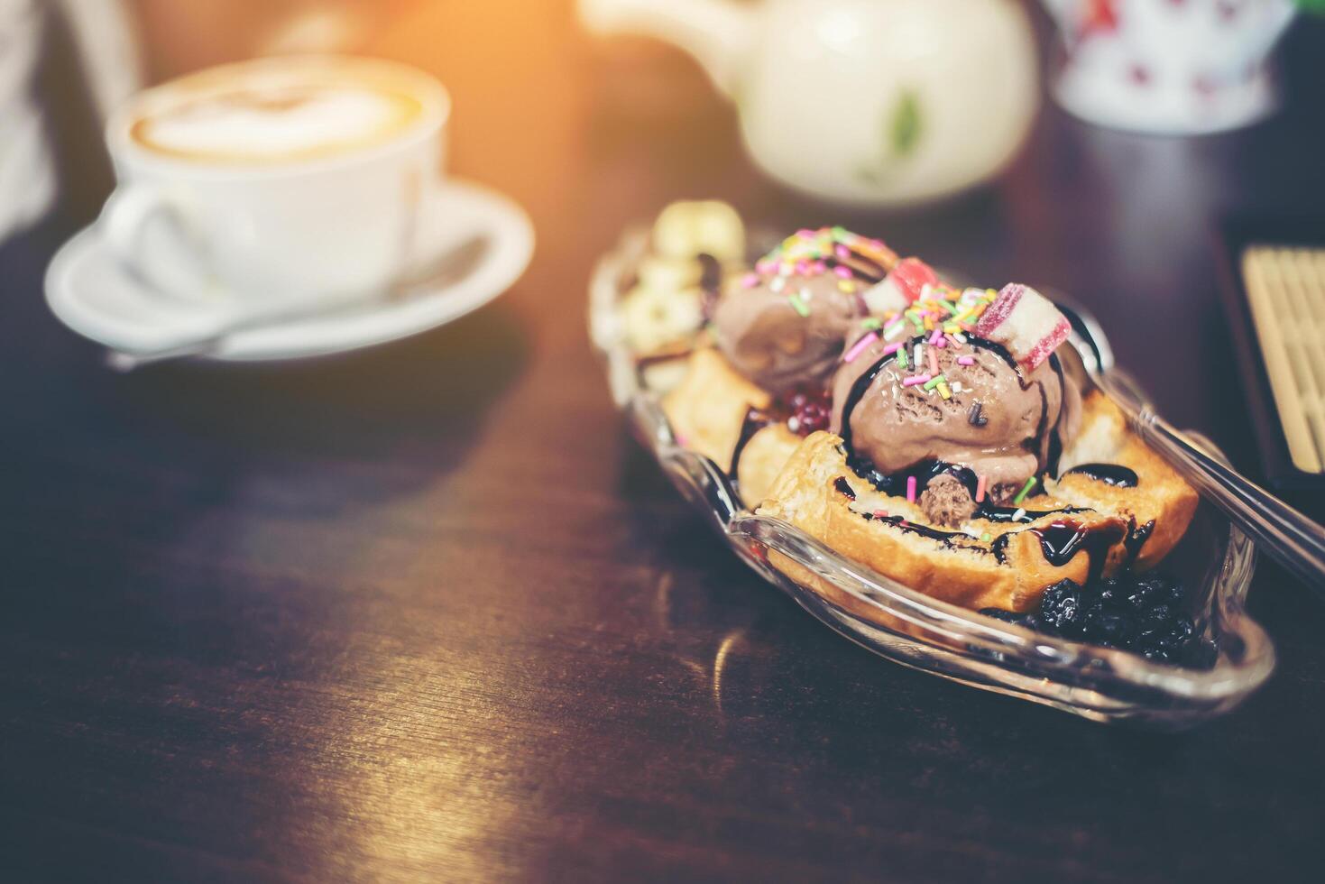 Banana split sunday ice cream in a bowl with strawberry. photo