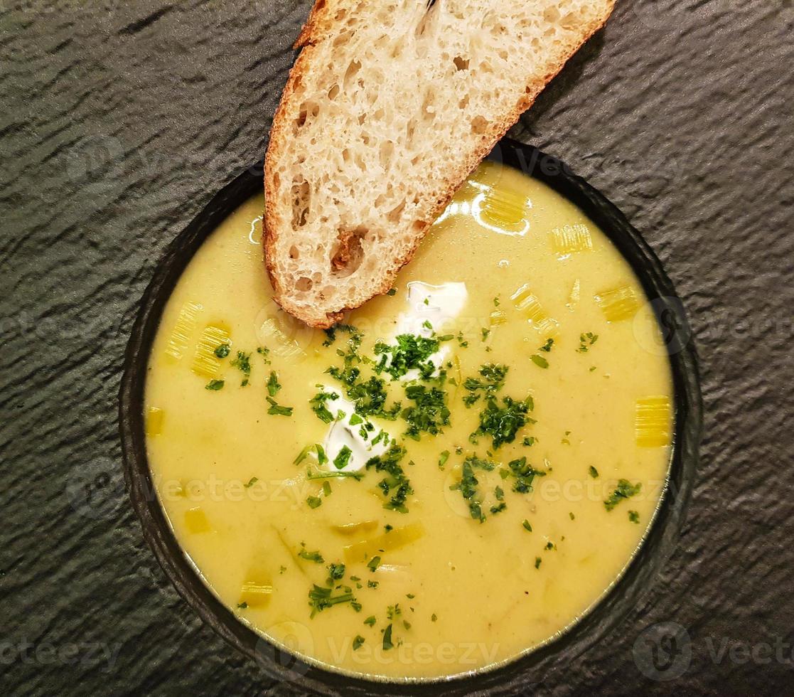 Spicy curry soup with bread photo